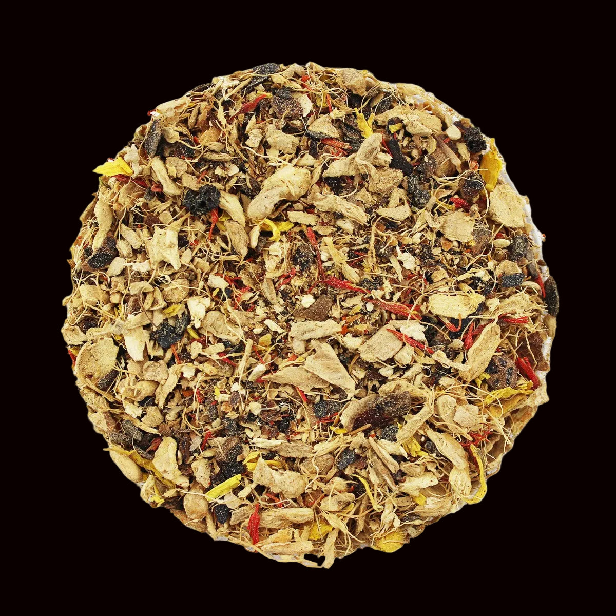 Tea ball with various herbs and leaves on a black background